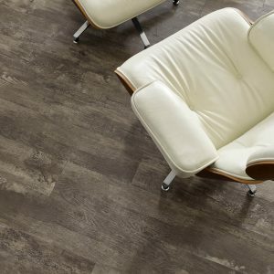 Luxury vinyl flooring with a chair | Allied Flooring & Paint
