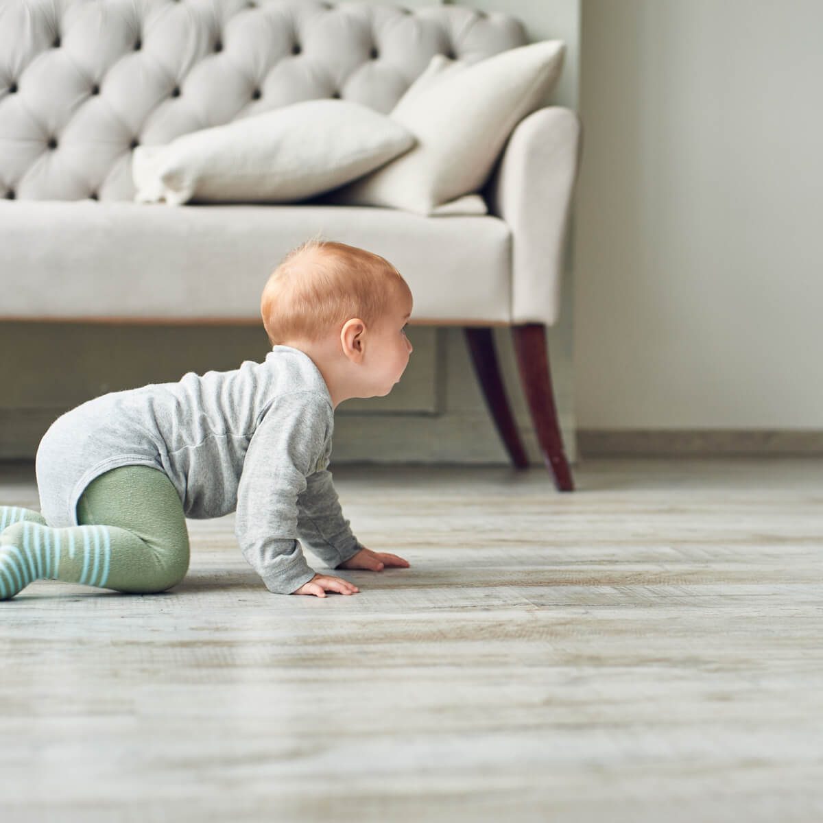 Baby crawling on vinyl floor | Allied Flooring & Paint