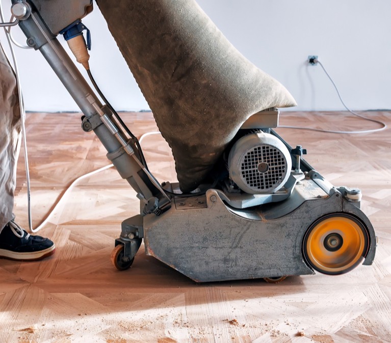 Sander on hardwood flooring | Allied Flooring & Paint
