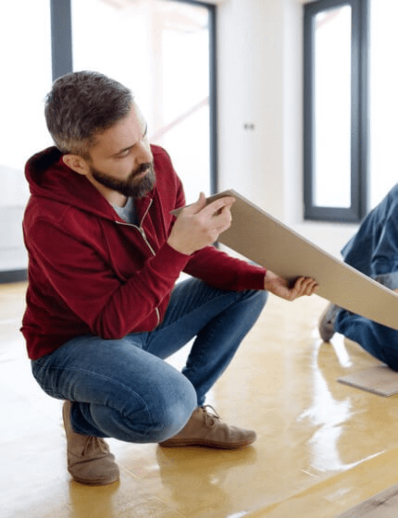 Man installing vinyl flooring | Allied Flooring & Paint