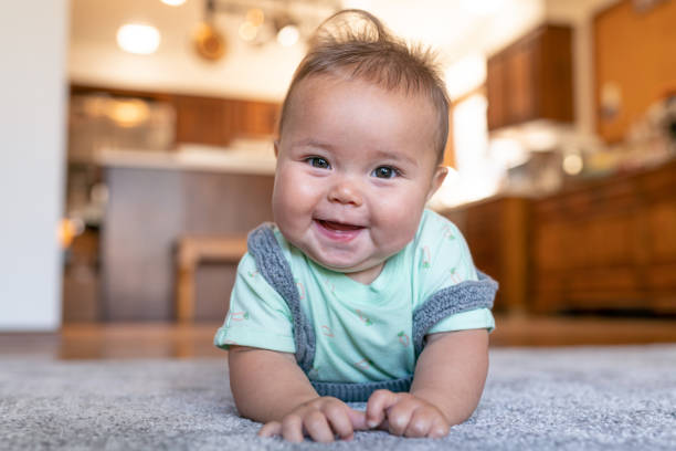 Baby laying on carpet floorings | Allied Flooring & Paint