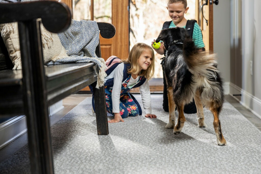 Kids playing with dog on carpet floors | Allied Flooring & Paint